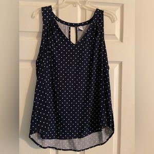 Sleeveless navy and white polka dot top